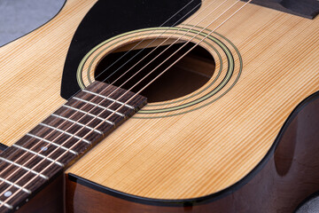 Obraz premium Classical guitar close up. Acoustic guitar on wood background.Music instrument concept