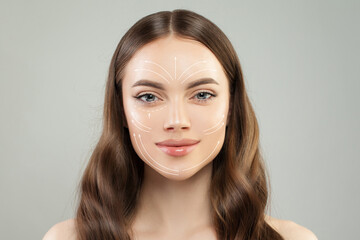 Grid of lines showing facial lifting effect on fresh skin of beautiful young woman with healthy...