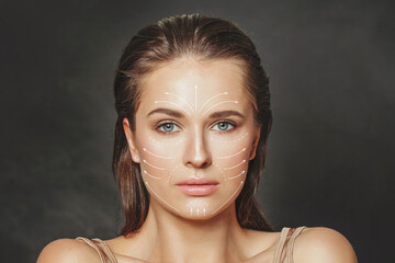 Skin care and technology. Portrait of beautiful woman face with drawn massage and surgery lines.