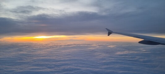 Clouds and sky as seen through window of an aircraft