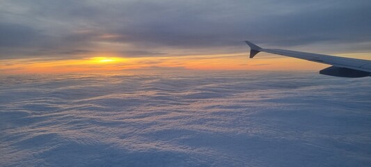 Clouds and sky as seen through window of an aircraft