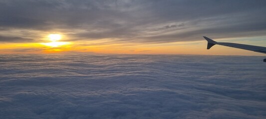 Clouds and sky as seen through window of an aircraft