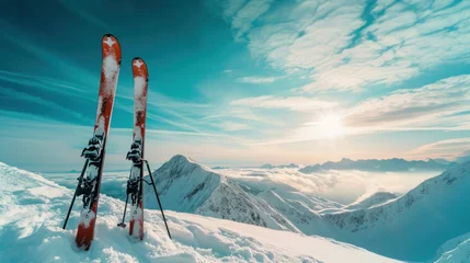 Fotobehang Ski in winter season, mountains and ski touring backcountry equipments on the top of snowy mountains in sunny day © Ruslan Gilmanshin