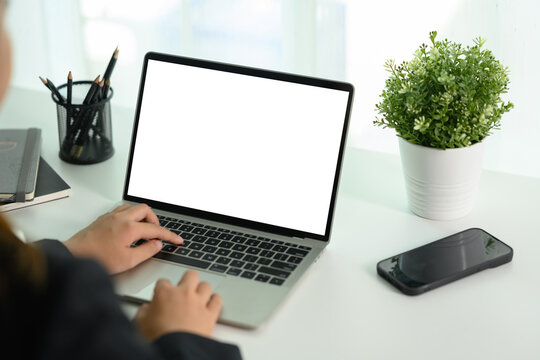 Cropped shot businesswoman typing on laptop keyboard. Blank display for your text