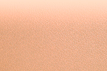 Close up of peach fuzz leather gradient background. Light peach leather texture. Trend color year 2024 peach fuzz, gradient color, blur texture