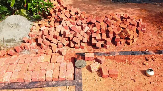 The red blocks were piled up, Construction using earthen blocks, Building the foundation of the house, Workers work at a construction site in India, Building a house with red stone ,