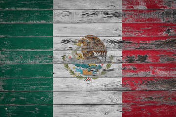 The national flag of  Mexico  is painted on uneven wooden  boards. Country symbol.