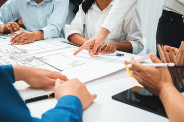 Diverse group of civil engineer and client working together on architectural project, reviewing construction plan and building blueprint at meeting table. Prudent - obrazy, fototapety, plakaty
