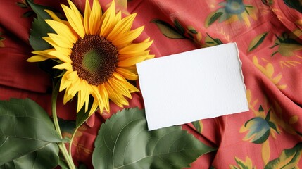 Blank white card with sun flower on the red green fabric