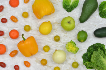 Colorful fruits and vegetables on a light background, kitchen table, top view. 