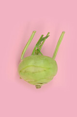 Kohlrabi on a pink background, abstraction, concept, top view, isolated. 