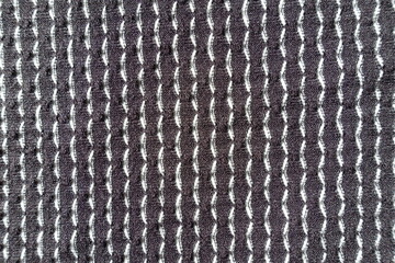 Texture of black and white jersey fabric with geometric pattern