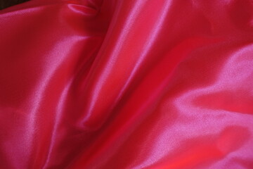 Rippled bright reddish pink satin polyester fabric