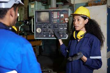 worker or engineer training and teaching how to use machine control with coworker in factory