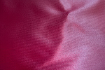 Texture of smooth cold pink satin polyester fabric