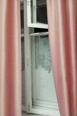 Fototapeta premium An old wooden window covered with ice and frost.