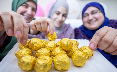 Females having sweets together feeling excited , hospitality concept for muslim females