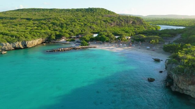 Aerial orbit rises to establish hidden beach cove getaway