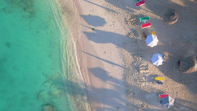 Drone top down rising above white sandy shores of Daaibooi beach Curacao