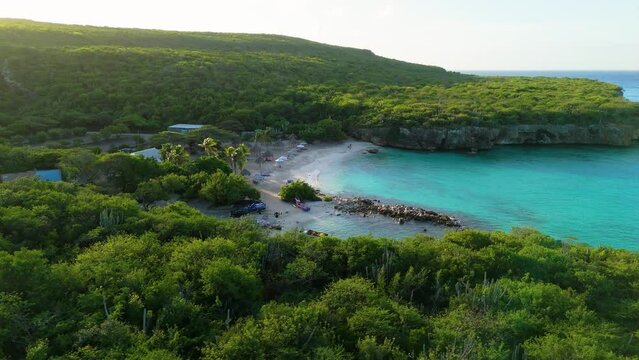 Aerial parallax around crystal clear water cove of Daaibooi beach Curacao