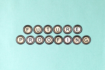 Future Proofing spelt out using vintage fridge magnets over teal green textured paper