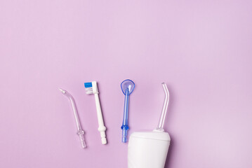 Oral hygiene set Oral teeth irrigator dental floss tongue scraper Pink background Dental care...