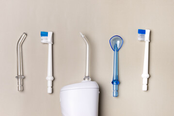 Oral hygiene set Oral teeth irrigator dental floss tongue scraper Beige background Dental care...