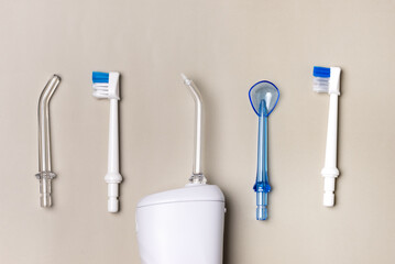 Oral hygiene set Oral teeth irrigator dental floss tongue scraper Beige background Dental care treatments daily routine Horizontal Long Banner