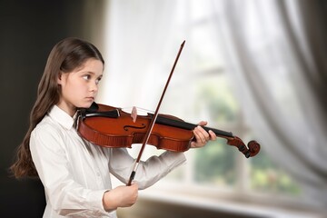 Cute child girl playing violin music instrument