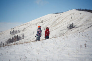 Adventurous Couple Standing on Snowy Hill, Enjoying Spectacular Scenic View of Winter Landscape
