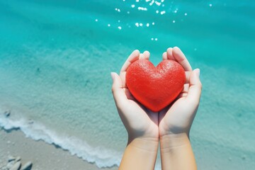 Love symbolized by hands holding heart at the ocean's edge.Travel and Honeymoon Promotions concept,Wellness and Relaxation Campaigns concept,Relationship and Dating Apps concept.