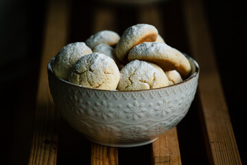 delicious cookies sprinkled with powdered sugar in a beautiful bowl