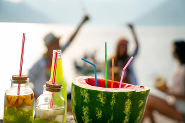 Trendy group of friends drinking cocktails at party. Young people having fun on luxury resort.
