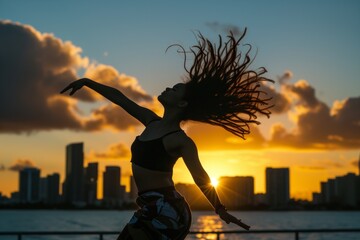 dancer with skyline backdrop during sunset