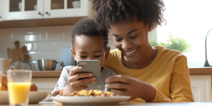 A woman and child are seen looking at a cell phone. This image can be used to illustrate technology usage, family bonding, or digital communication.