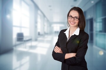 Headshot portrait of confident businesswoman on office background.