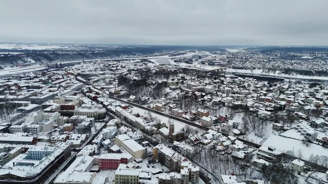 Buildings and houses covered in winter snow, Kaunas Lithuania. Drone video