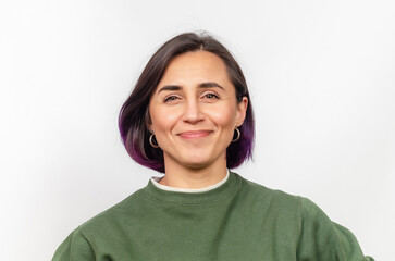Close-up portrait of Caucasian woman with dark purple hair in natural makeup and green sweater.