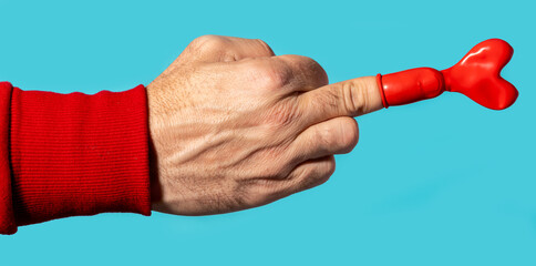Unrecognizable person middle finger with heart shaped balloon