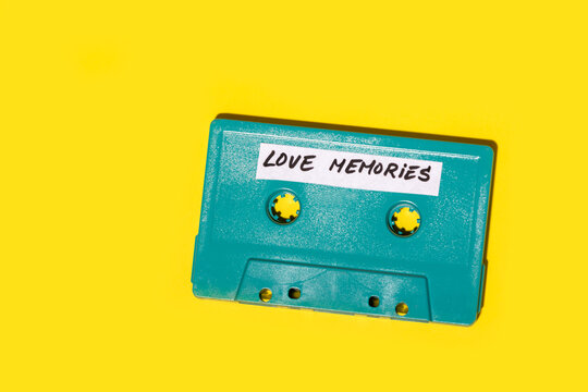 Retro blue cassette placed on yellow surface