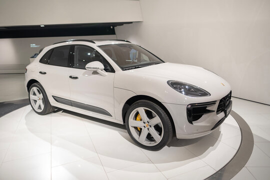 white Porsche Macan GTS, 4x4 all-wheel drive, elegance sports Car in showroom, sustainable development, Innovation in automotive industry Porsche AG show in Stuttgart, Germany - January 26, 2024