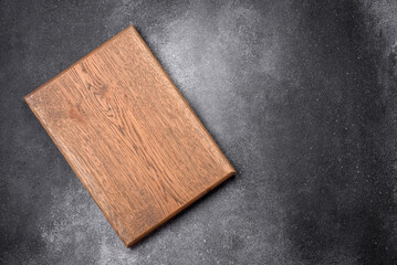 Empty wooden cutting board on a light texture background