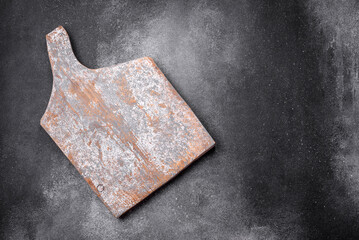 Empty wooden cutting board on a light texture background