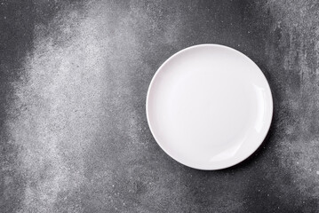 Empty round ceramic plate on a light texture background