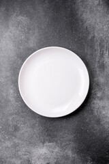 Empty round ceramic plate on a light texture background