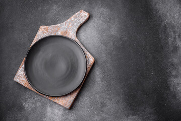 Empty round ceramic plate on a light texture background
