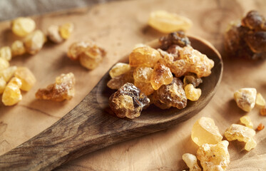 Frankincense resin crystals on an wooden spoon