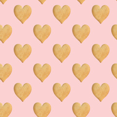 Seamless pattern of heart-shaped cookies on a delicate pink background. Valentine's Day. Cookie background. Top view, flat lay