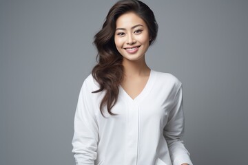Obraz premium Serene young lady of Asian descent dons comfortable white loungewear, exuding a peaceful expression against a backdrop of pure white. Generative AI.