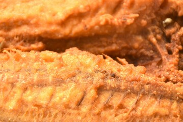 deep fried black-banded trevally fish on plate dipping spicy chili sauce  